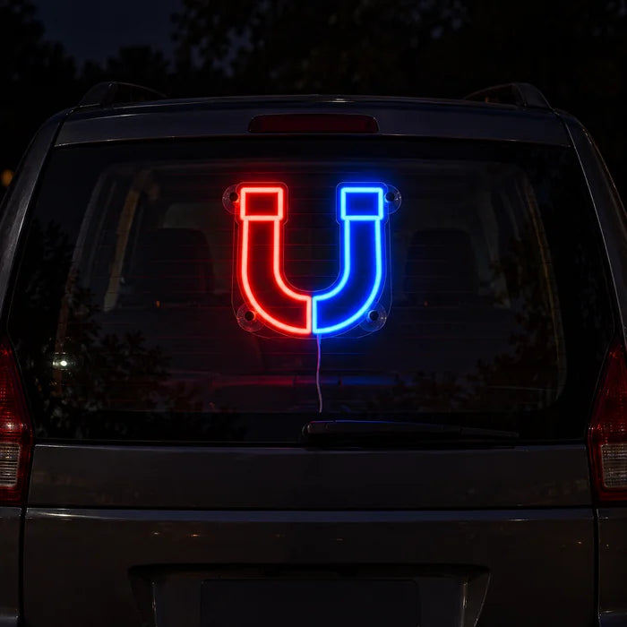 Magnetic Attraction Neon LED Sign on the rear window of a car at night