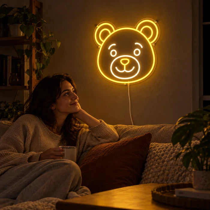Bear Smile Neon LED Sign on a living room wall, a person relaxing on the sofa in front of it