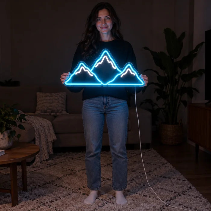 Mountain Silhouette Neon LED Sign held by a woman, showing its size compared to her body