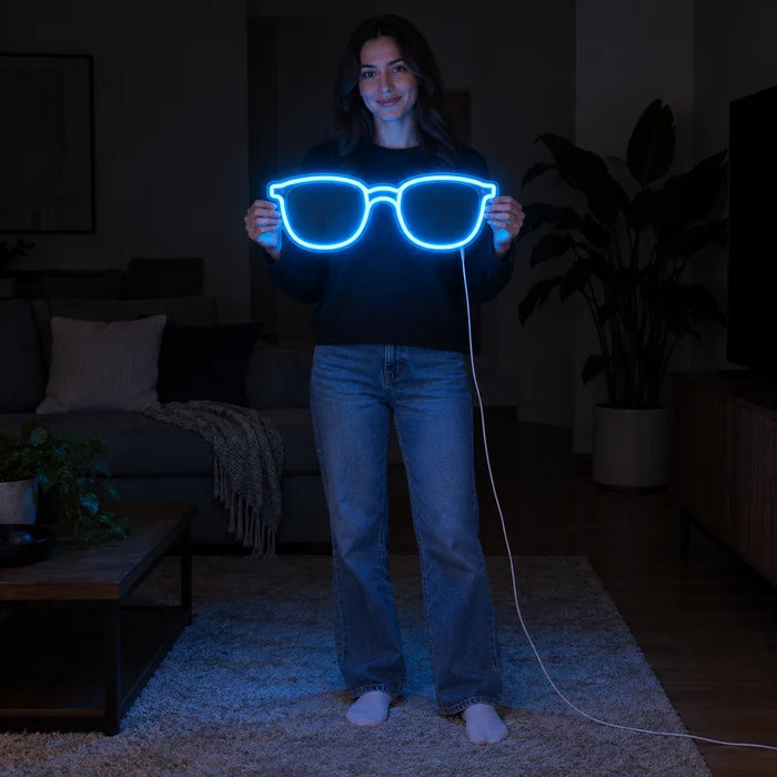 Blue Glasses Neon LED Sign held by a woman, showing its size compared to her body