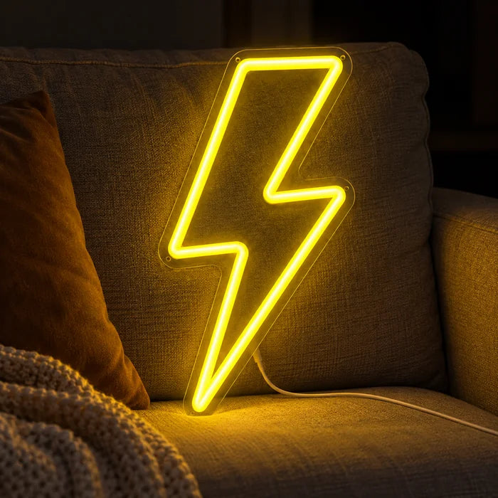 Lightning Bolt Neon LED Sign on a cosy sofa between cushions and a throw