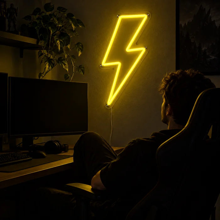 Lightning Bolt Neon LED Sign above a gaming desk, a gamer in a gaming chair in front of it