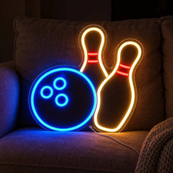 Bowling Night Neon LED Sign on a cosy sofa between cushions and a throw