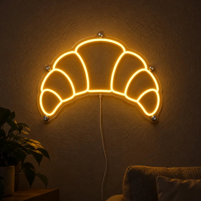 Butter Croissant Neon LED Sign glowing on a dark wall, close-up with connection cable