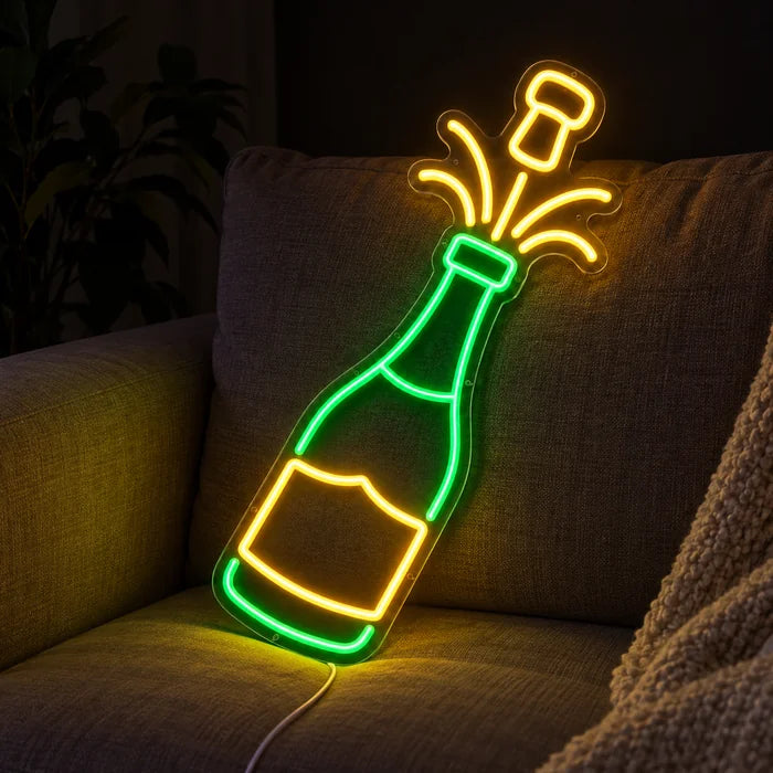 Champagne Neon LED Sign on a cosy sofa between cushions and a throw