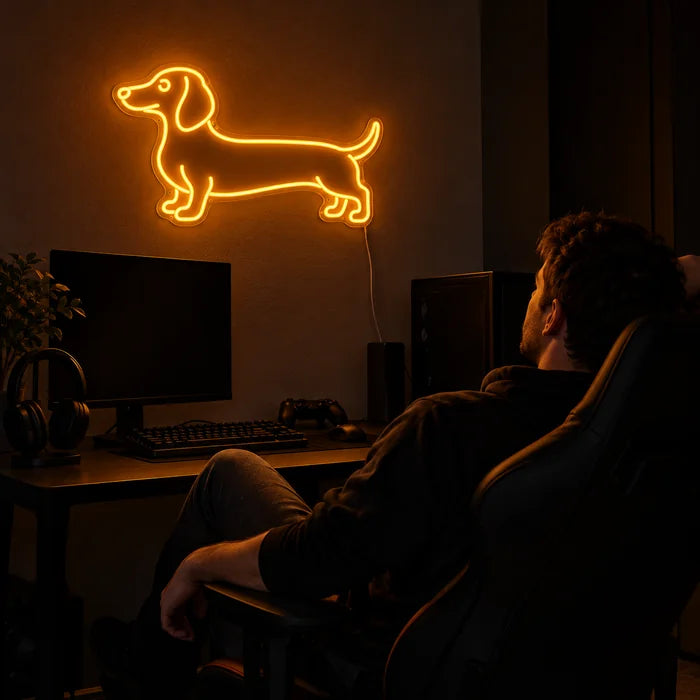 Dachshund Neon LED Sign above a gaming desk, a gamer in a gaming chair in front of it
