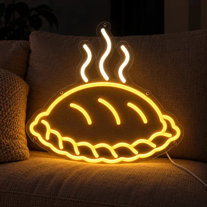 Steaming Dumpling Neon LED Sign on a cosy sofa between cushions and a throw