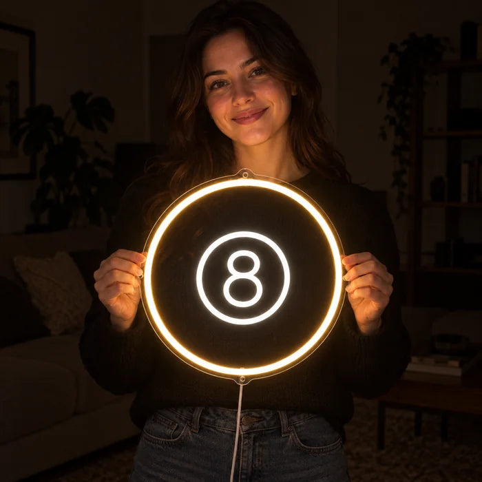 Black Eight Ball Neon LED Sign held by a smiling woman against a dark background