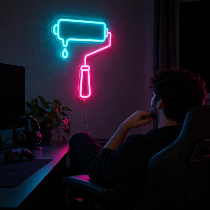 Paint Roller Neon LED Sign above a gaming desk, a gamer in a gaming chair in front of it