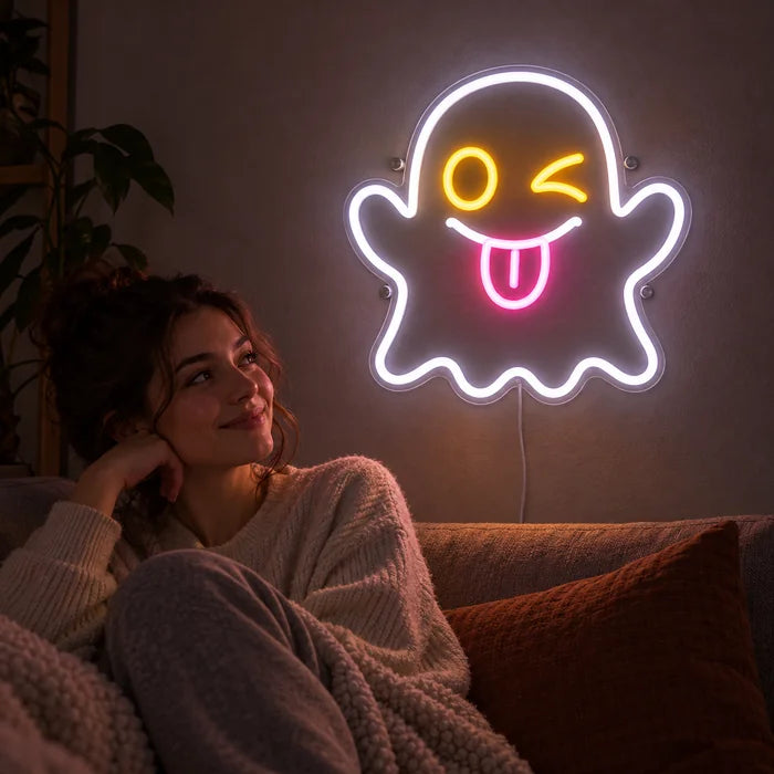 Cheeky Ghost Neon LED Sign on a living room wall, a person relaxing on the sofa in front of it