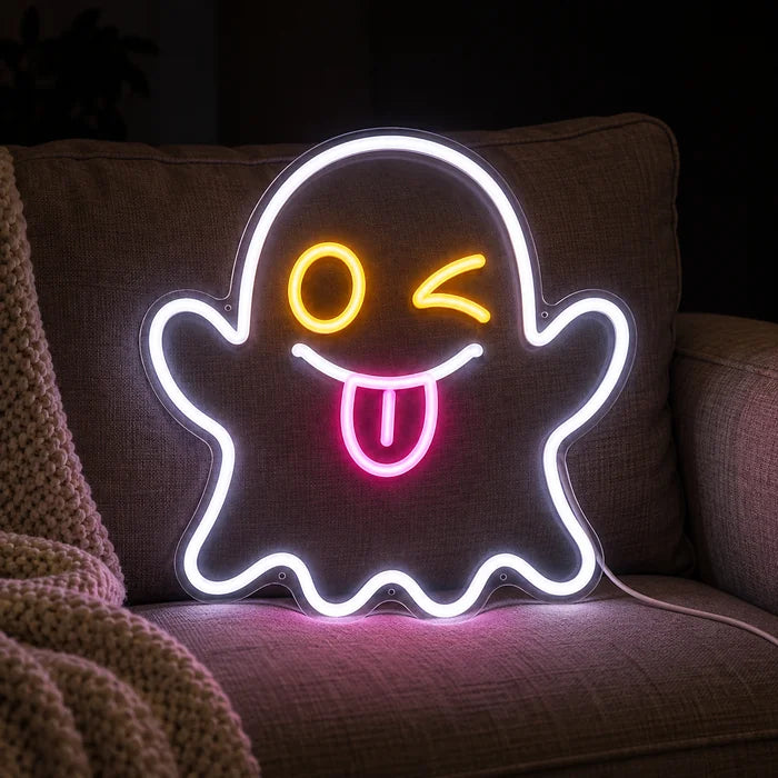 Cheeky Ghost Neon LED Sign on a cosy sofa between cushions and a throw