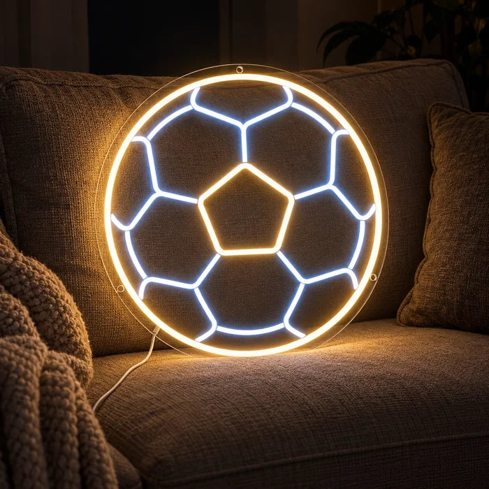 Football Neon LED Sign on a cosy sofa between cushions and a throw