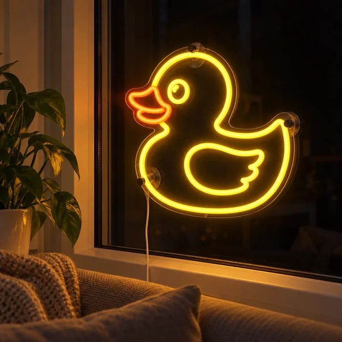 Yellow Duck Neon LED Sign in the window of a cosy living room in the evening