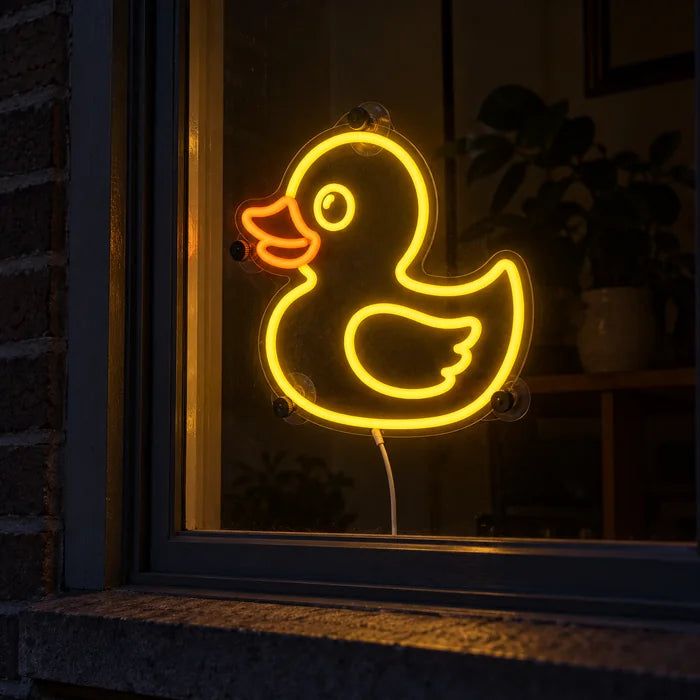 Yellow Duck Neon LED Sign in a window, seen from the street at night