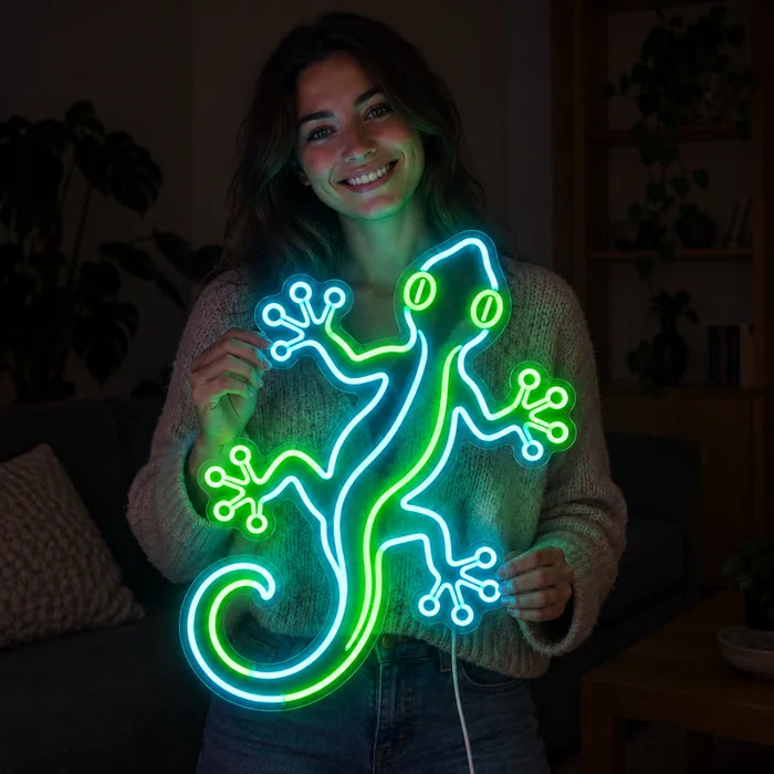 Green Gecko Neon LED Sign held by a smiling woman against a dark background