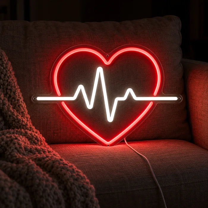 Heartbeat Neon LED Sign on a cosy sofa between cushions and a throw