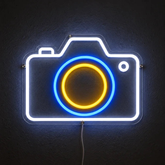 Camera Neon LED Sign glowing on a dark wall, close-up with connection cable