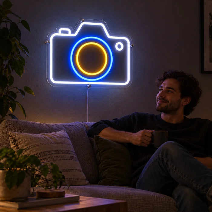 Camera Neon LED Sign on a living room wall, a person relaxing on the sofa in front of it