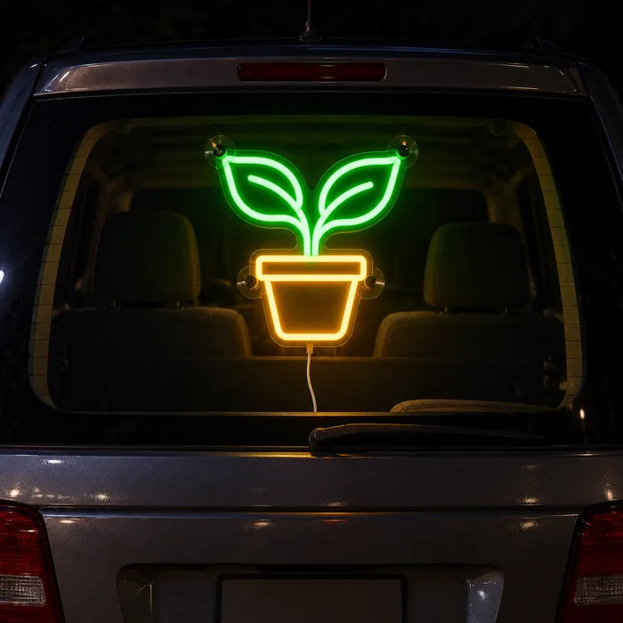 Little Sprout Neon LED Sign on the rear window of a car at night