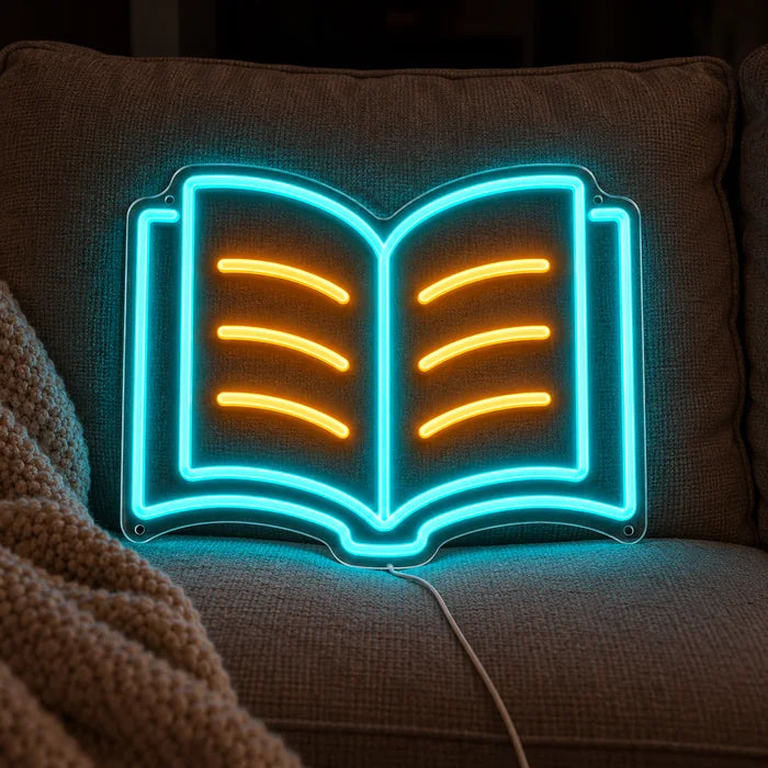 Læsebog neon LED skilt på en hyggelig sofa mellem puder og tæppe