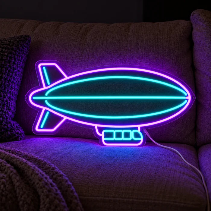 Airship Neon LED Sign on a cosy sofa between cushions and a throw
