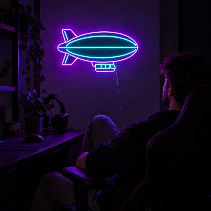 Airship Neon LED Sign above a gaming desk, a gamer in a gaming chair in front of it
