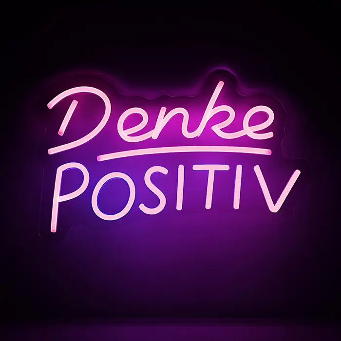 Denke Positiv Neon LED Schild in Rosa auf dunkler Wand, Schriftzug Denke über POSITIV mit Unterstreichung