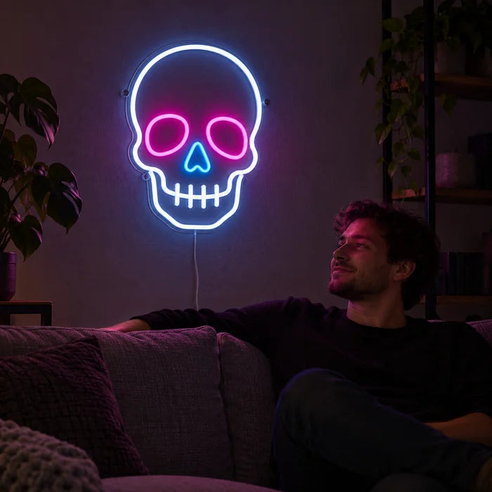 Neon Skull Neon LED Sign on a living room wall, a person relaxing on the sofa in front of it