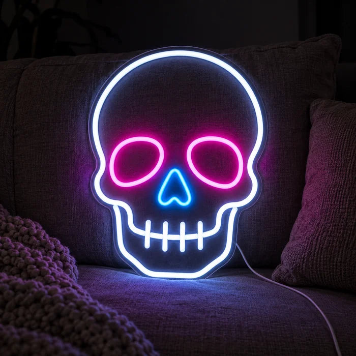 Neon Skull Neon LED Sign on a cosy sofa between cushions and a throw