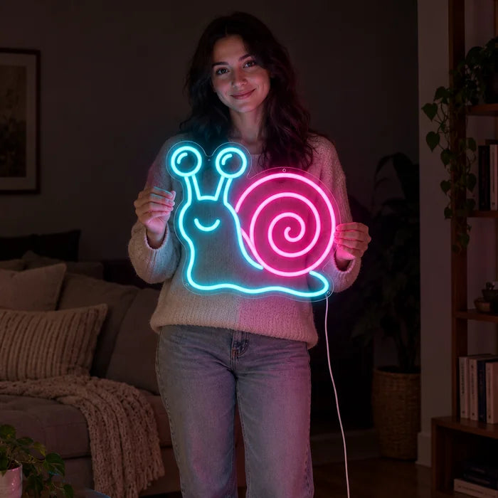 Neon Snail Neon LED Sign held by a woman, showing its size compared to her body
