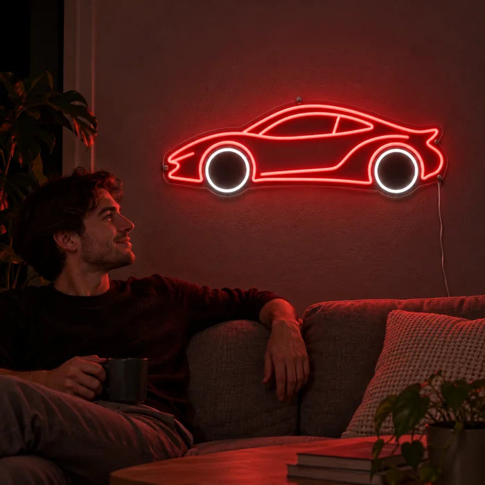 Neon Sports Car Neon LED Sign on a living room wall, a person relaxing on the sofa in front of it