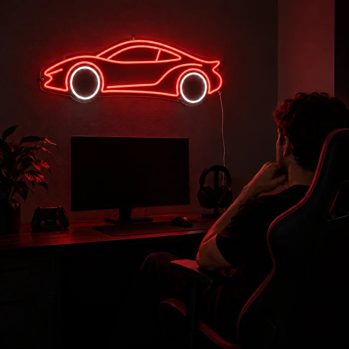 Neon Sports Car Neon LED Sign above a gaming desk, a gamer in a gaming chair in front of it