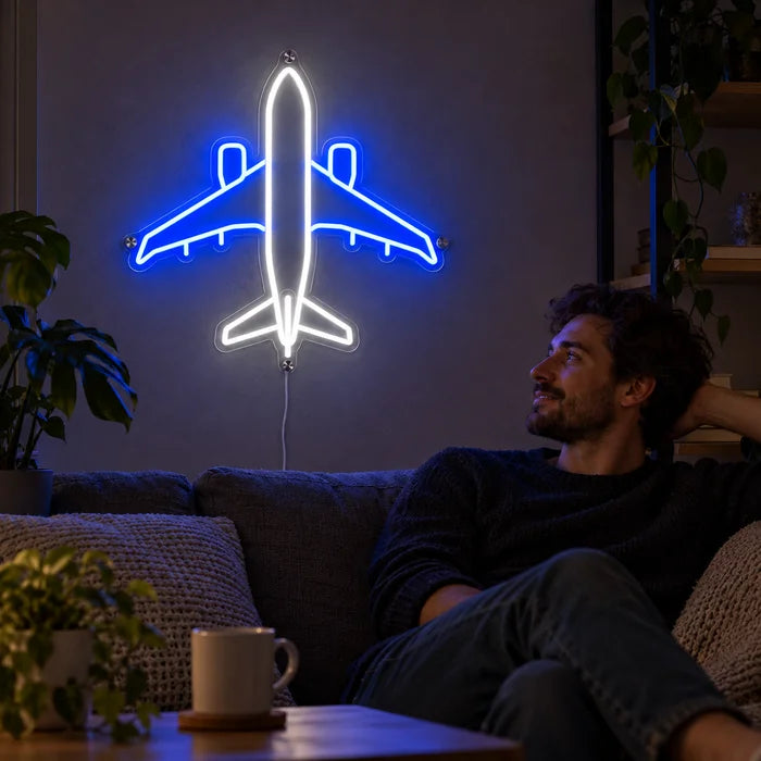 Passenger Plane Neon LED Sign on a living room wall, a person relaxing on the sofa in front of it