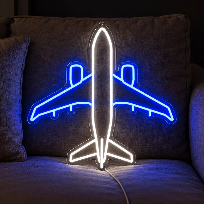 Passenger Plane Neon LED Sign on a cosy sofa between cushions and a throw