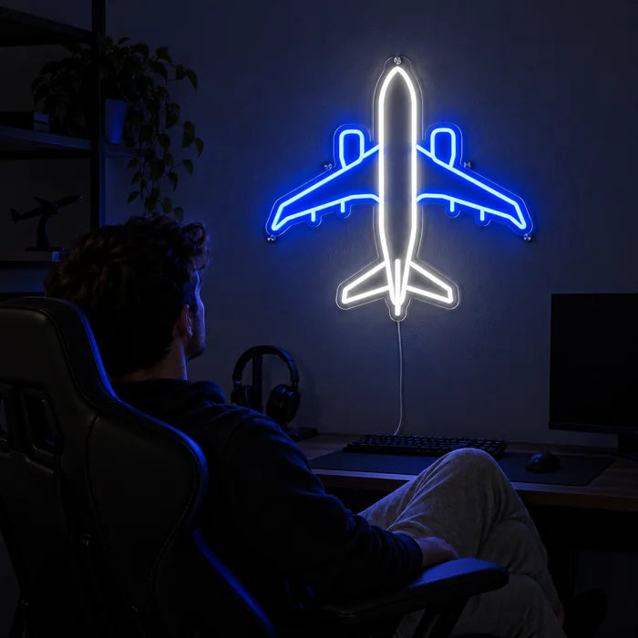 Passenger Plane Neon LED Sign above a gaming desk, a gamer in a gaming chair in front of it