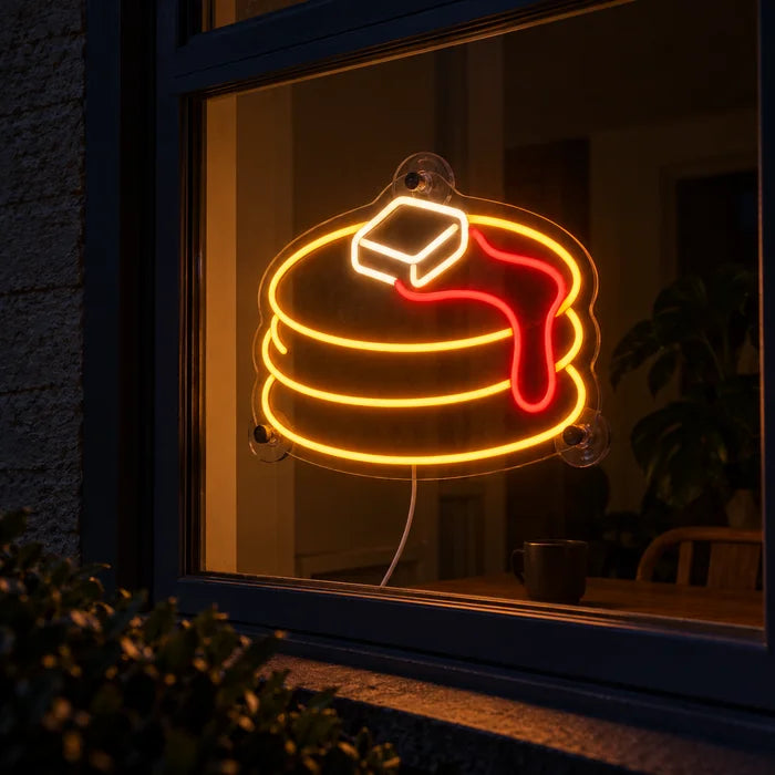 Pancakes Neon LED Sign in a window, seen from the street at night
