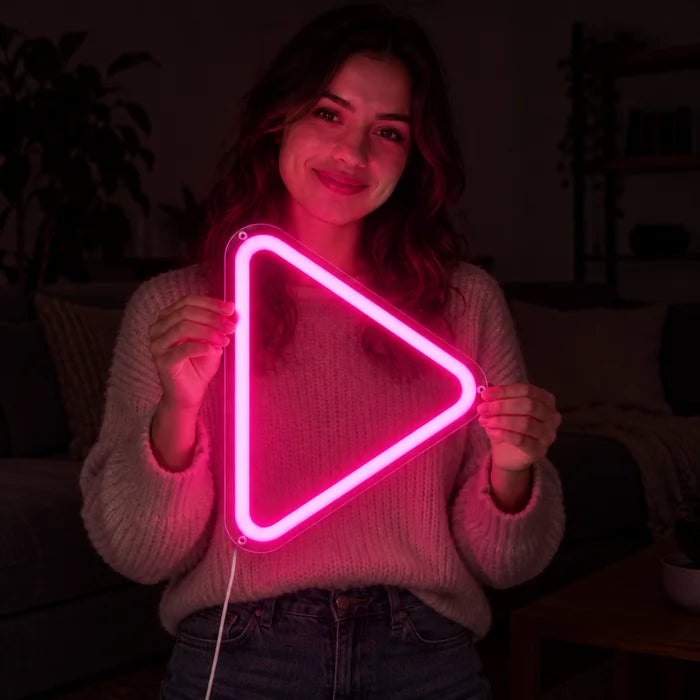 Play Button Neon LED Sign held by a smiling woman against a dark background