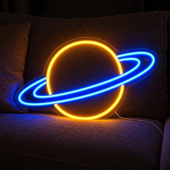Ringed Planet Neon LED Sign on a cosy sofa between cushions and a throw