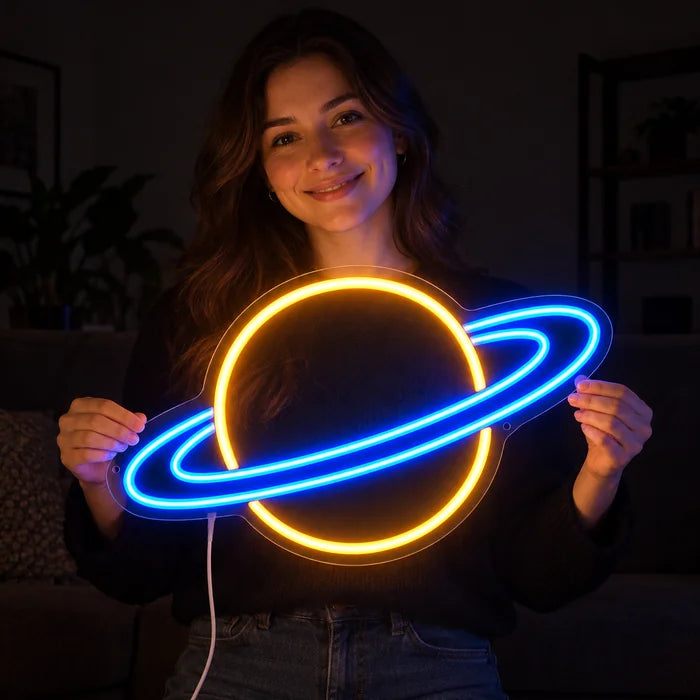 Ringed Planet Neon LED Sign held by a smiling woman against a dark background