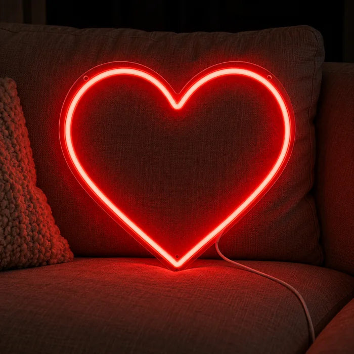 Red Heart Neon LED Sign on a cosy sofa between cushions and a throw