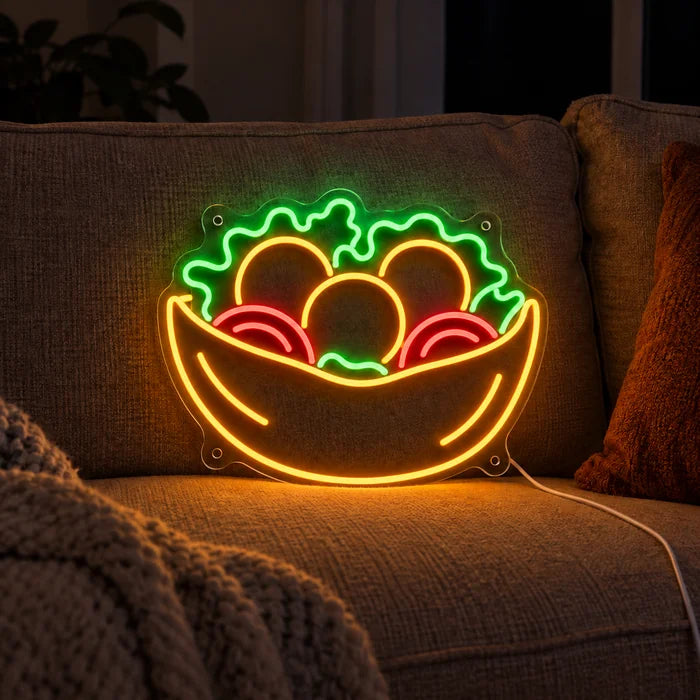 Salad Bowl Neon LED Sign on a cosy sofa between cushions and a throw