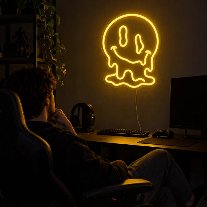 Melting Skull Neon LED Sign above a gaming desk, a gamer in a gaming chair in front of it