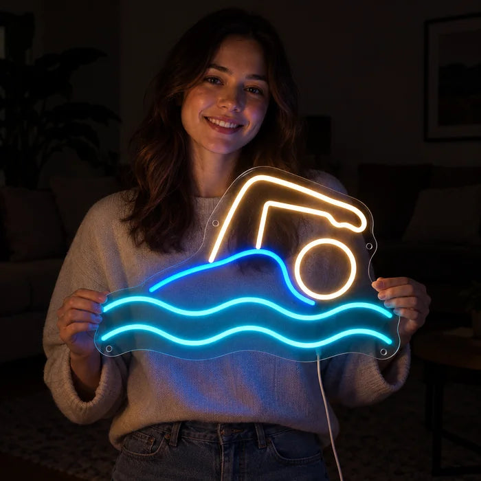 Swimmer Neon LED Sign held by a smiling woman against a dark background