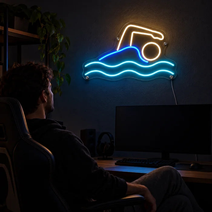 Swimmer Neon LED Sign above a gaming desk, a gamer in a gaming chair in front of it