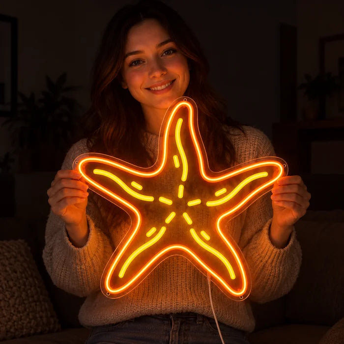 Starfish Neon LED Sign held by a smiling woman against a dark background