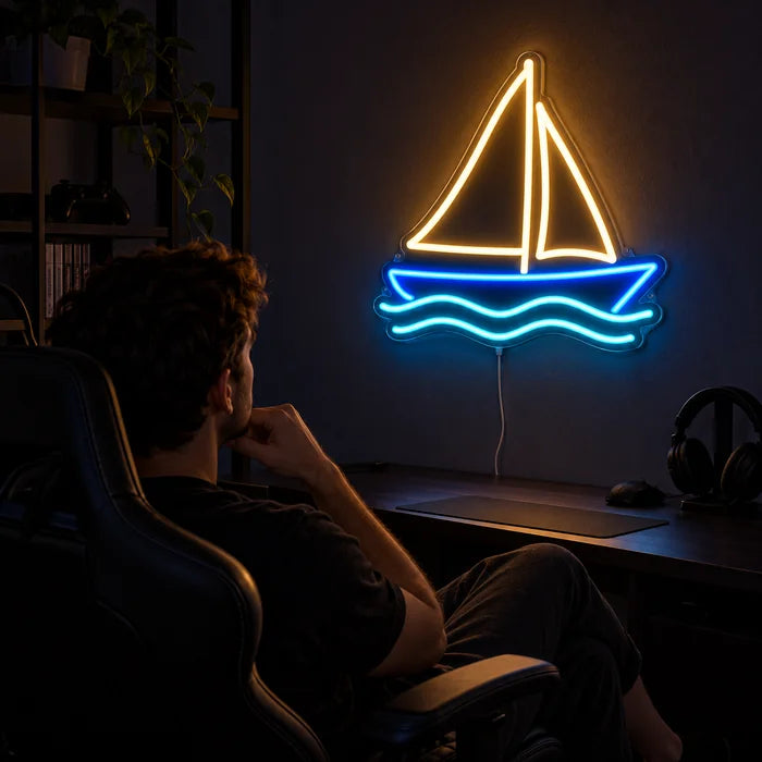 Sailing Boat Neon LED Sign above a gaming desk, a gamer in a gaming chair in front of it
