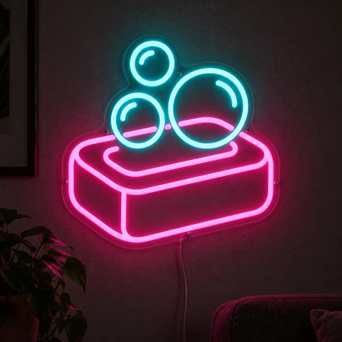 Soap Bubbles Neon LED Sign glowing on a dark wall, close-up with connection cable