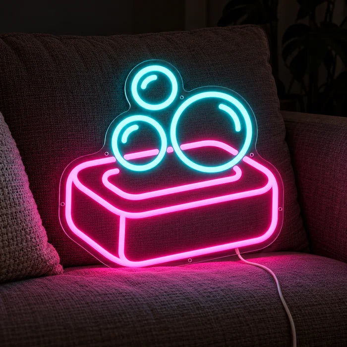 Soap Bubbles Neon LED Sign on a cosy sofa between cushions and a throw