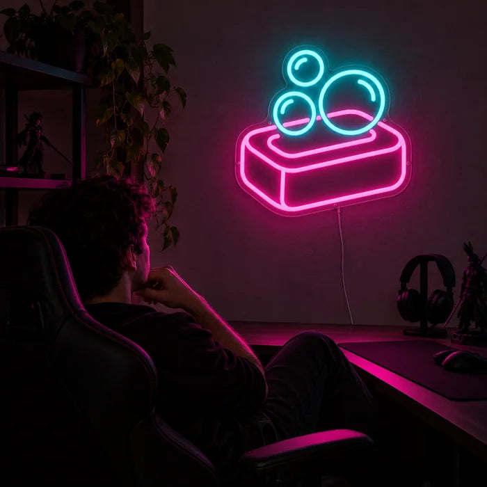 Soap Bubbles Neon LED Sign above a gaming desk, a gamer in a gaming chair in front of it