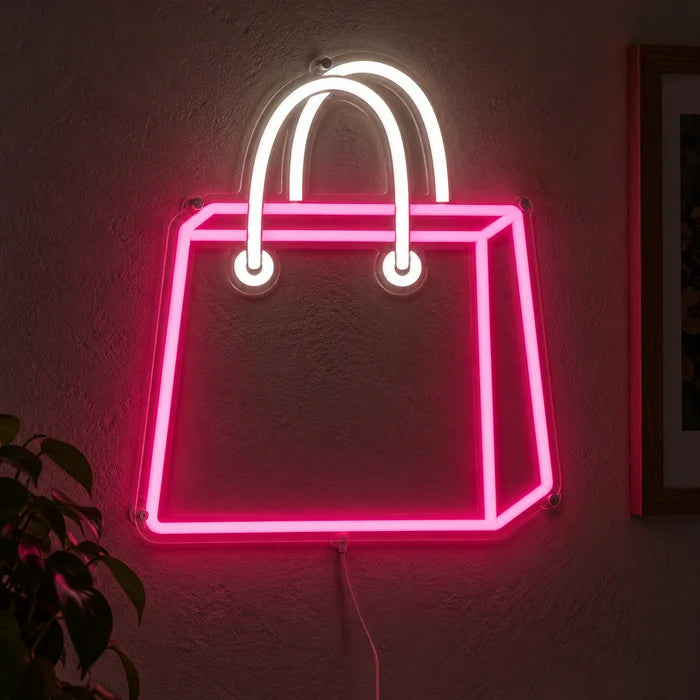 Shopping Bag Neon LED Sign glowing on a dark wall, close-up with connection cable